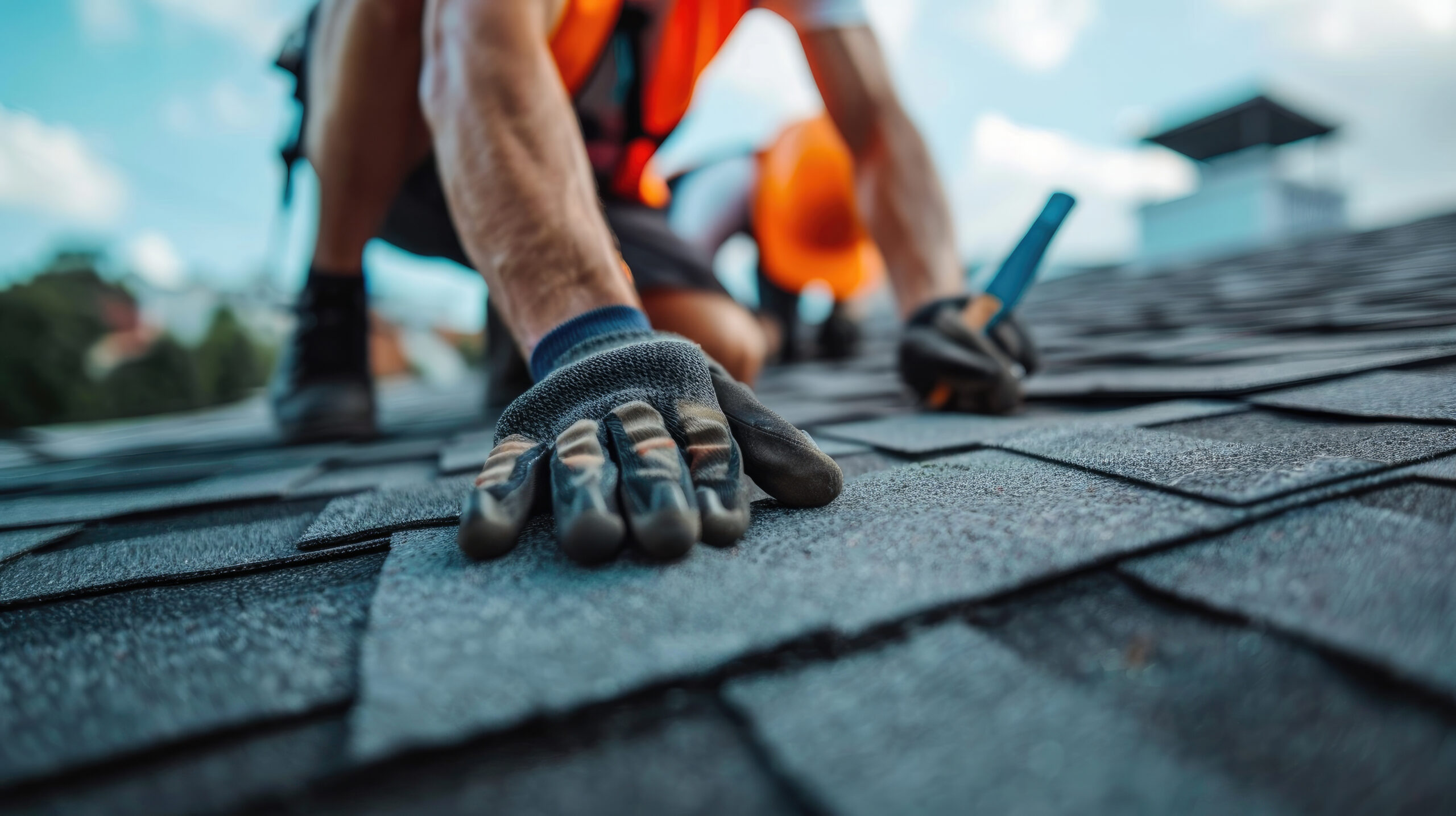 Close-up of a professional roofing contractor installing new shingles, demonstrating professional roofing services and home exterior remodeling services.