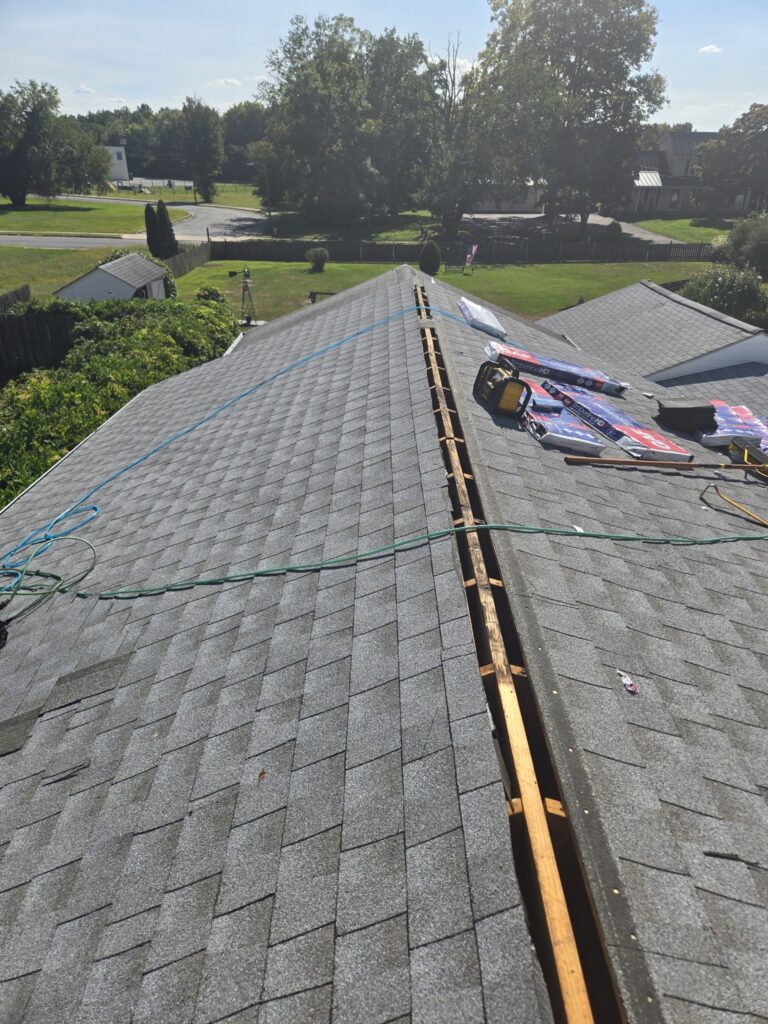 A roofing installation crew is working on a new roof for a residential home, showcasing exterior home improvement services near me with professional roofing services.